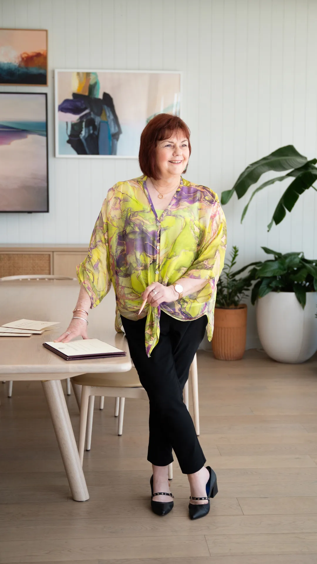 A photo of Jill Venn sitting on a couch.